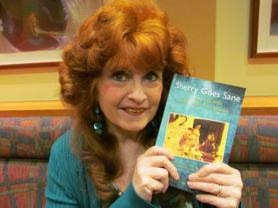 Sherry Joiner holds a copy of her recently released book 'Sherry Goes Sane.' The cover features a photo of her and her Aunt Deanna.